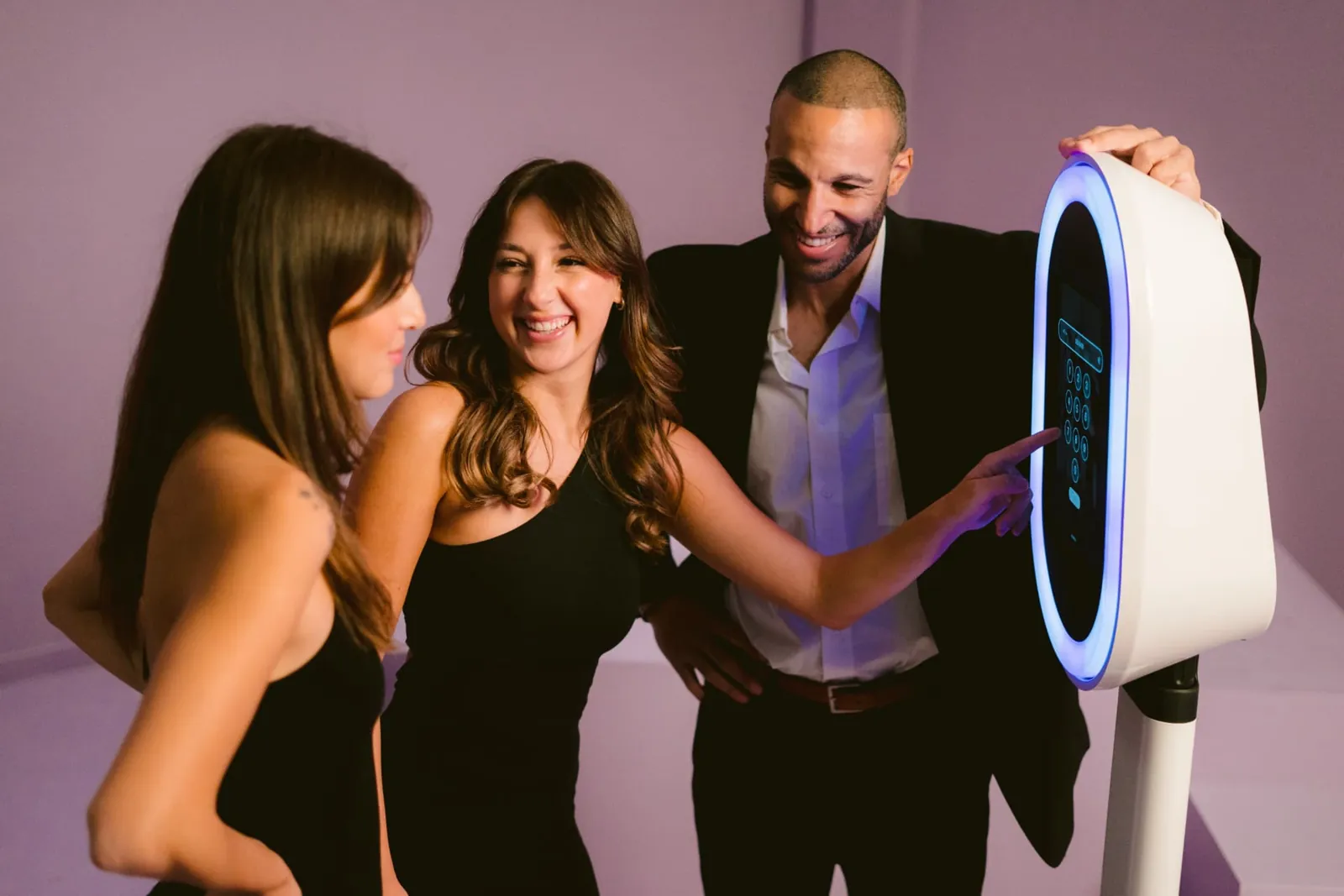 Guests smiling and using an EverGlow open-air photo booth at a quinceañera celebration